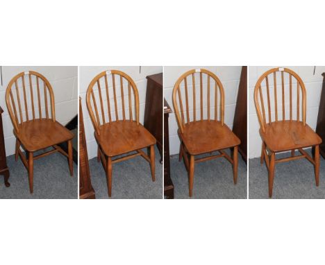 A set of four Ercol stick back dining chairs 