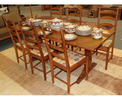 An Ercol pine refectory table and six ladder back chairs (7)