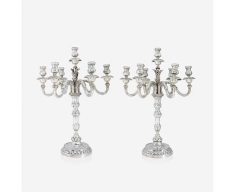 A pair of Italian silver seven-light candelabra 20th century Convertible to single candlesticks; each marked to underside and