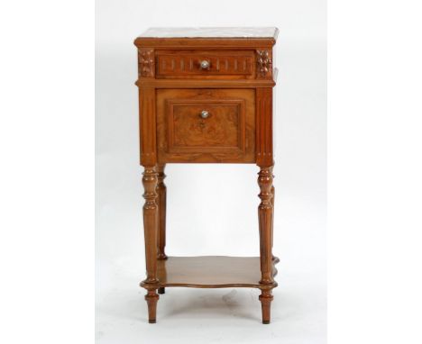 EARLY TWENTIETH CENTURY CONTINENTAL CARVED FIGURED WALNUT WOOD BEDSIDE CABINET with variegated marble inlet top over drawer a