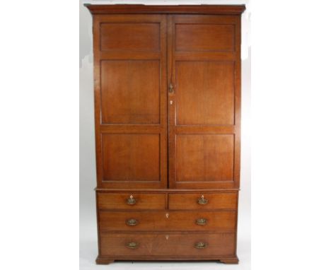 LATE NINETEENTH/EARLY TWENTIETH CENTURY OAK LINEN PRESS/WARDROBE, the moulded cornice above a pair of three panelled cupboard