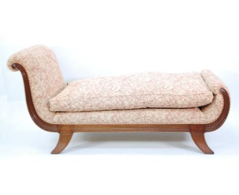 19TH CENTURY PROBABLY CONTINENTAL CARVED MAHOGANY DAY BED with reeded scroll ends and the squab cushion, re-upholstered in fl