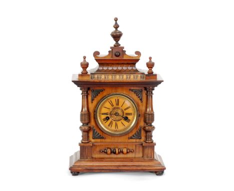 EARLY TWENTIETH CENTURY H.A.C., GERMAN, CARVED WALNUTWOOD AND BEECH MANTEL CLOCK, the 4 1/4" Roman dial with pierced  gilt ce