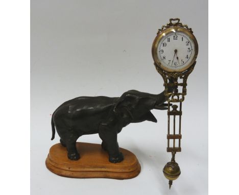 EARLY TWENTIETH CENTURY SPELTER ELEPHANT MYSTERY CLOCK, with pivoting brass cased timepiece, 2" Arabic enamel dial and moveme