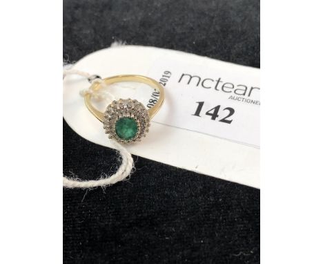 GREEN GEM SET AND DIAMOND CLUSTER RING, set with a central oval green gem surrounded by round diamonds, in nine carat gold, s