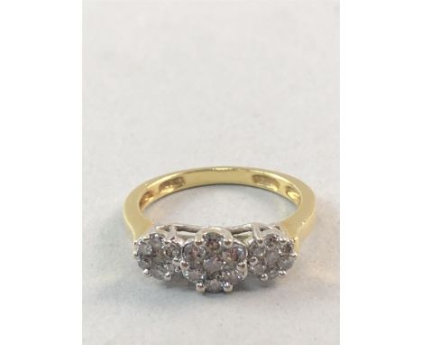 DIAMOND DRESS RING, set with three clusters of small round brilliant cut stones, in gold