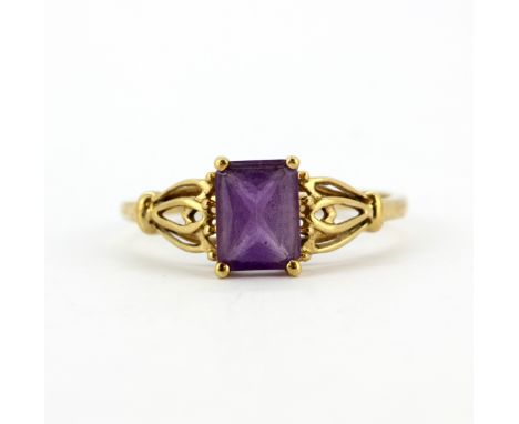 A 9ct yellow gold ring set with emerald cut amethyst, (T.5).