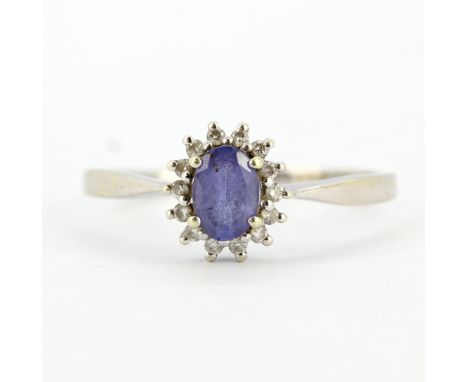 A 9ct white gold tanzanite and diamond set cluster ring, with certificate, (T.5).