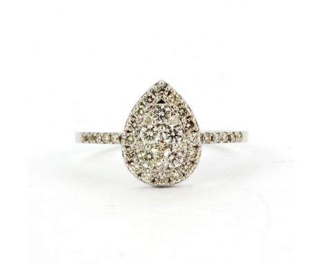 An 18ct white gold (stamped 18k) pear shaped ring set with brilliant cut diamonds, (M.5).