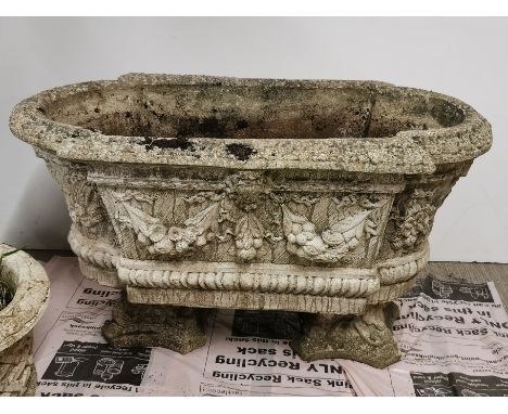 A large concrete garden planter with relief decoration on two separate feet/ bases, 80 x 42 x 47cm.