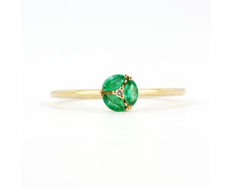 An 18ct yellow gold (stamped 750) ring set with marquise cut emeralds and a brilliant cut diamond, (O).