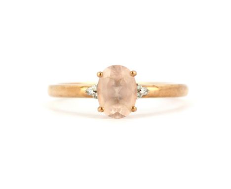 A 9ct rose gold ring set with an oval cut morganite and diamond set shoulders, (T.5).