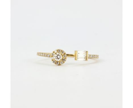 An 18ct yellow gold (stamped 750) ring set with baguette and brilliant cut diamonds, (O).