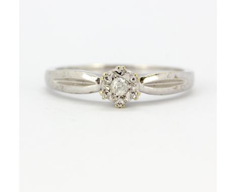 A 9ct white gold (stamped 375) diamond set solitaire ring, (M.5).