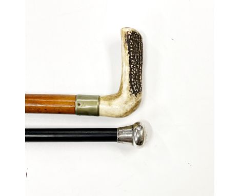 A hallmarked silver topped walking cane and a horn handled walking stick.