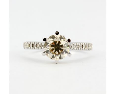 An 18ct white gold (stamped 18ct) solitaire ring set with a brilliant cut diamond and diamond set shoulders, centre stone 1.9