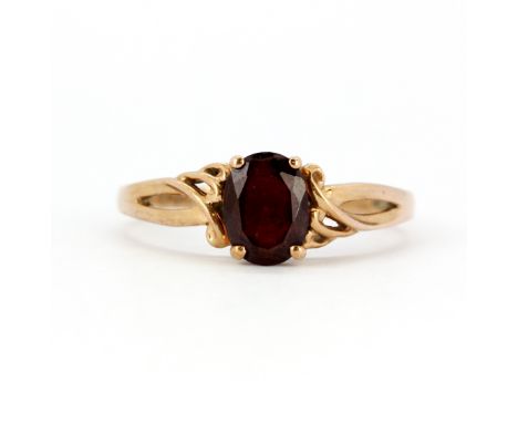 A 9ct rose gold (stamped 375) ring set with an oval cut garnet, (T.5).