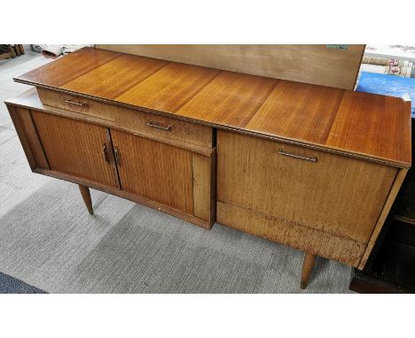 A 1970's teak sideboard with sliding door and a drop down cabinet with glass shelf, 145 x 79 x 45cm.