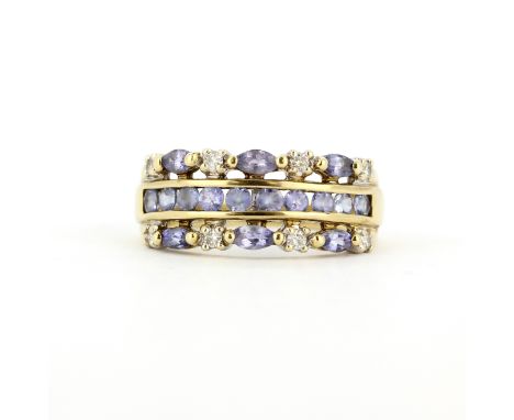 A hallmarked 9ct yellow gold ring set with marquise and round cut tanzanites and diamonds, (P.5).