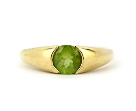 A 9ct yellow gold ring set with a round cut peridot, (T.5).