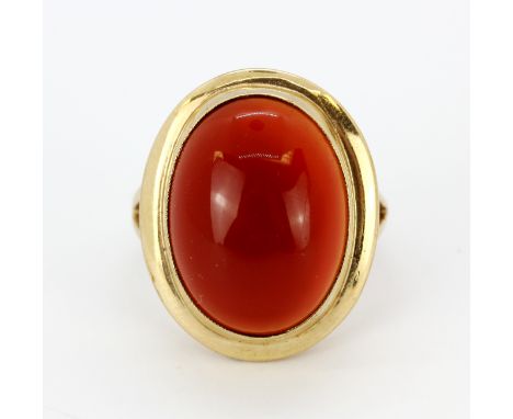 A 9ct yellow gold ring set with a large cabochon cut cornelian, (L.5).