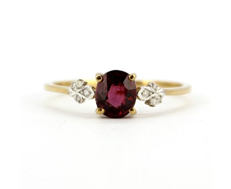 A 9ct yellow gold ring set with a rubellite garnet and diamonds, (T.5).