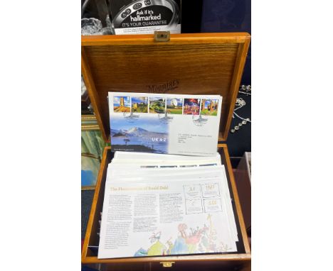 A box of first day cover stamps.