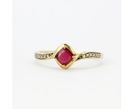 A 9ct yellow gold ring set with a red stone and diamond set shoulders, (T).