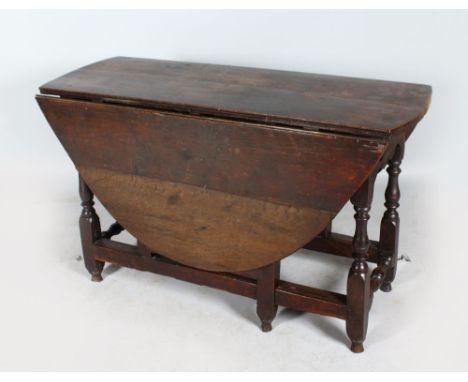 AN 18TH CENTURY OAK GATE LEG OVAL DINING TABLE with drop flaps and gate leg action. 4ft 4ins x 3ft 9ins.