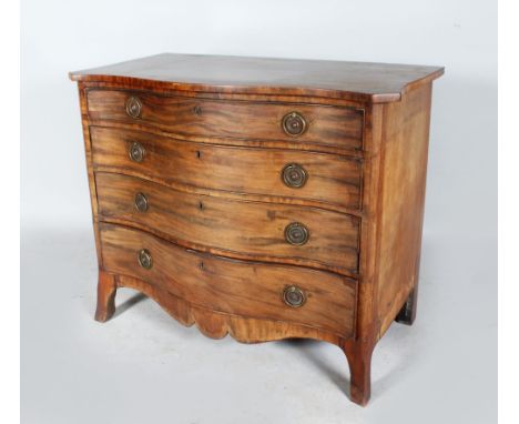 A GEORGE III MAHOGANY SERPENTINE FRONTED COMMODE with plain top, four long graduated drawers with circular brass handles and 