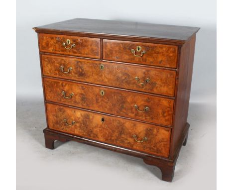AN 18TH CENTURY WALNUT STRAIGHT FRONT CHEST with cross-banded top, two short and three long graduated drawers with brass hand