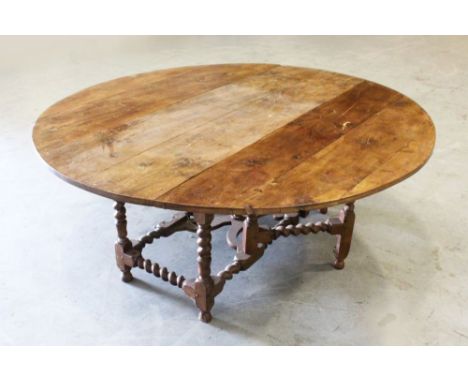 A RARE LARGE 18TH CENTURY YEW WOOD IRISH OVAL WAKE TABLE, with folding flaps and gate leg action, with barley twist legs. 6ft