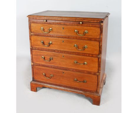 A GEORGE III MAHOGANY CHEST of four long graduated drawers with brass handles and brushing slide, supported on bracket feet.