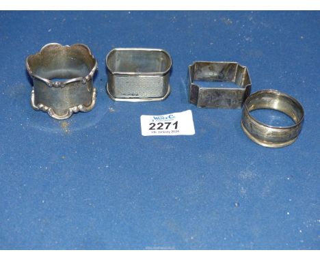 Four Silver napkin rings in various shapes, one engine turned.