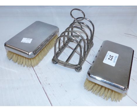 A silver 4 division toast rack; a pair of engine turned silver back hairbrushes