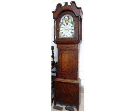 An early 19th century crossbanded oak longcase clock with turned columns and swan neck pediment to hood, three quarter length