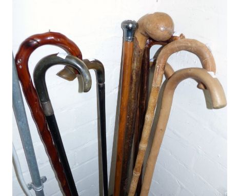 A Malacca cane stick with silver top; various others