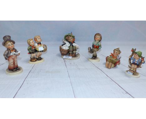 A collection of 6 Hummel figures:  children with animals, musical instruments; etc.