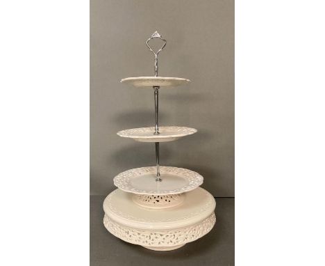 A White ceramic cake stand with pierced floral detail 
