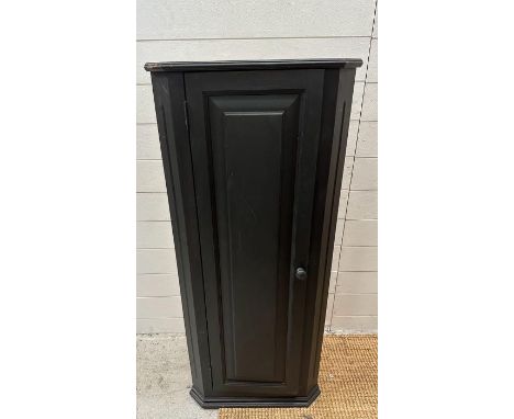 A black painted three shelf corner cabinet Height 117cms