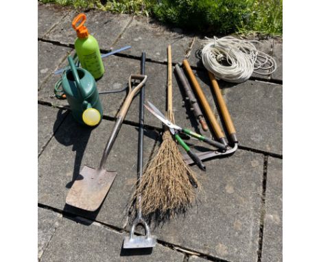 A collection of useful garden tools to include a watering can and green sprayer etc