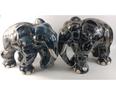 An unusually attractive pair of ceramic elephants glazed in colours of blue/grey/black with random grey textured patterning. 