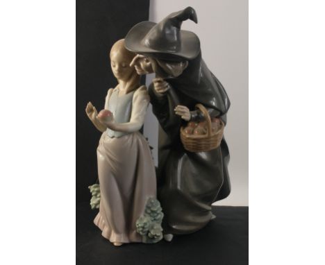 An expressive LLADRO figurine group of a young girl being offered an apple by an elderly woman in witch's hat. Nr.:E-21 F / 3