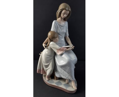 A LLADRO figurine of a lady and child reading from 1987 stands 27cm high, no cracks, chips or visible damageApprox 1 pieces