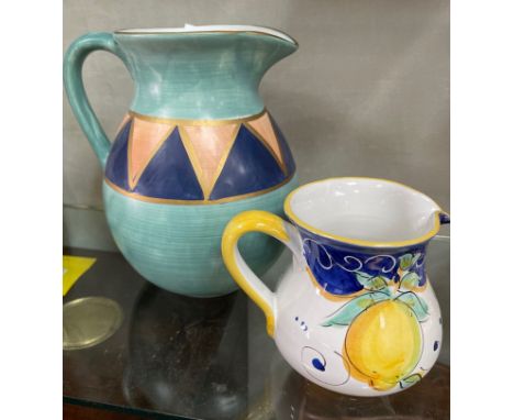 Two beautiful hand-painted and elegantly shaped jugs. The larger jug is approx. 20cm in diameter and 22cm in height painted i