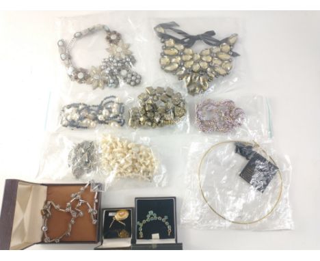 Costume jewellery necklaces, some boxed, made of various materials including faceted glass and shells.Approx 11 pieces
