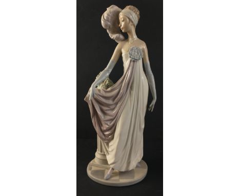 A beautiful LLADRO 1920s female figurine in flowing gown standing next to classical column and vase of greenery. Handmade in 