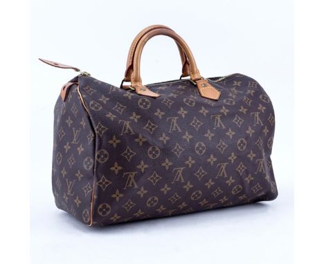 Louis Vuitton Brown Monogram Coated Canvas Speedy 35 Tote. Golden brass hardware, vachetta straps. Brown canvas interior with