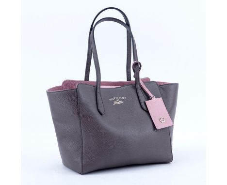Gucci Taupe/Light Pink Grained Leather Swing PM Handbag. Gold tone hardware, interior of beige fabric with zippered and patch