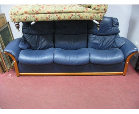 A Stressless Three Seater Reclining Sofa, fitted with individually reclining seats, shaped arms, in blue leather.